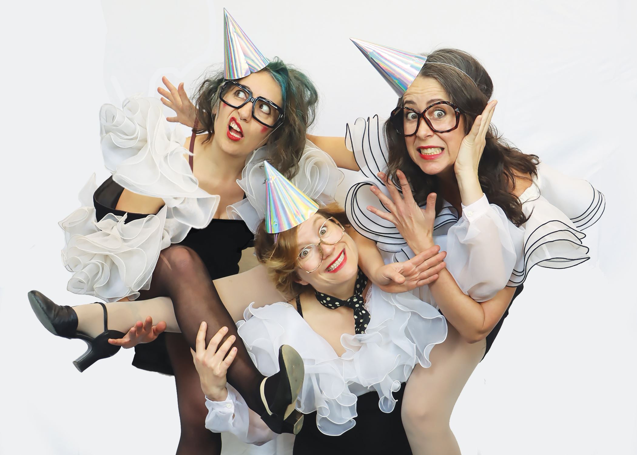 The three members of the band in black and white frilly clown costumes tangled up with each other