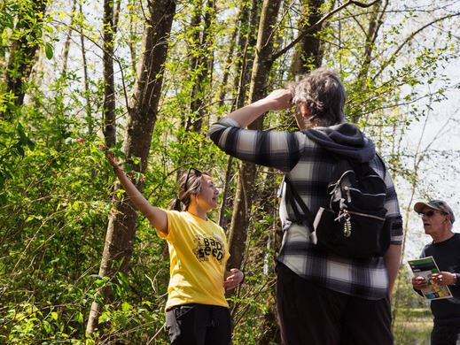 Park Spark team member with residents in park observing flaura