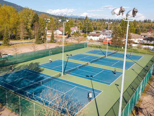 Aerial photo of tennis courts in Town Centre Park looking northeast towards the mountains