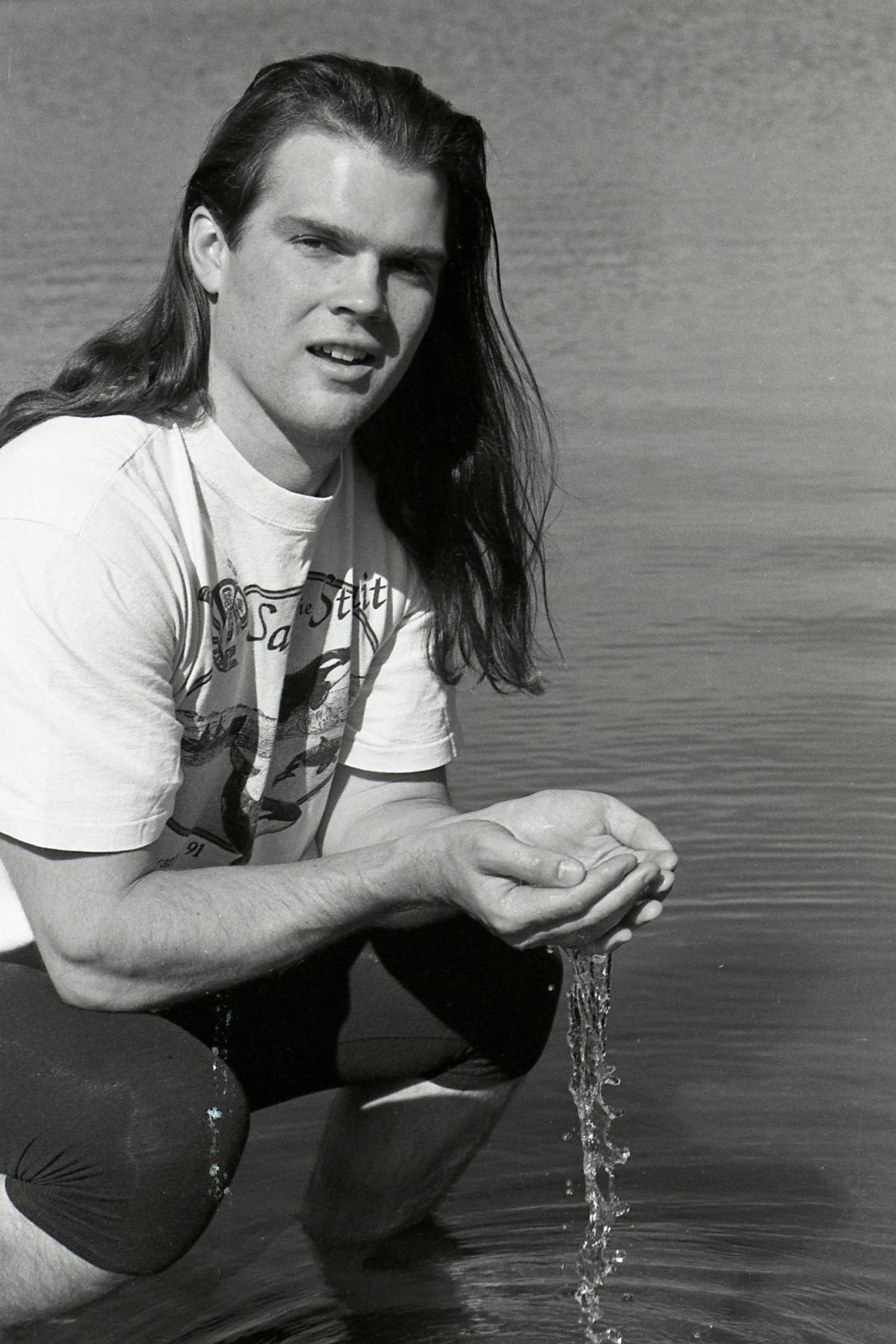 Fin Donnelly holding water in his hands at Lafarge Lake F13-S02-F13.2533